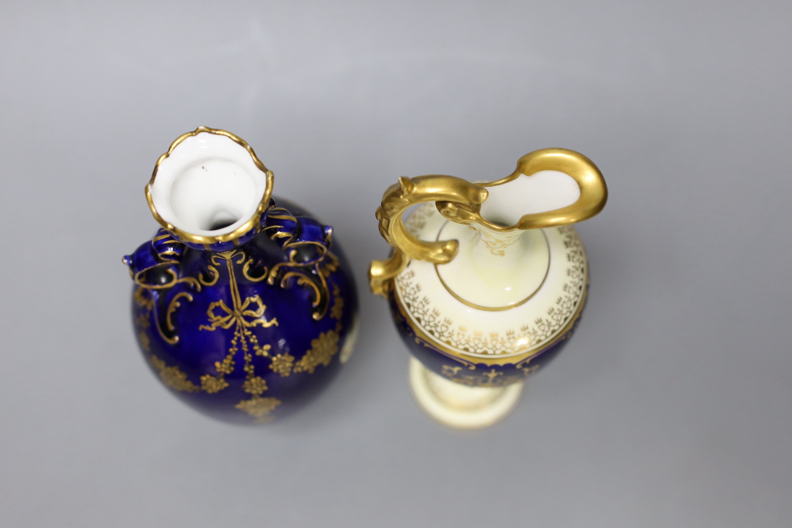A Coalport blue ground ewer, with a gilded oval panel with a loch scene, c.1900, and a Royal Crown Derby vase with raised gilded decoration on a cobalt blue ground, date code 1898, tallest 18cm